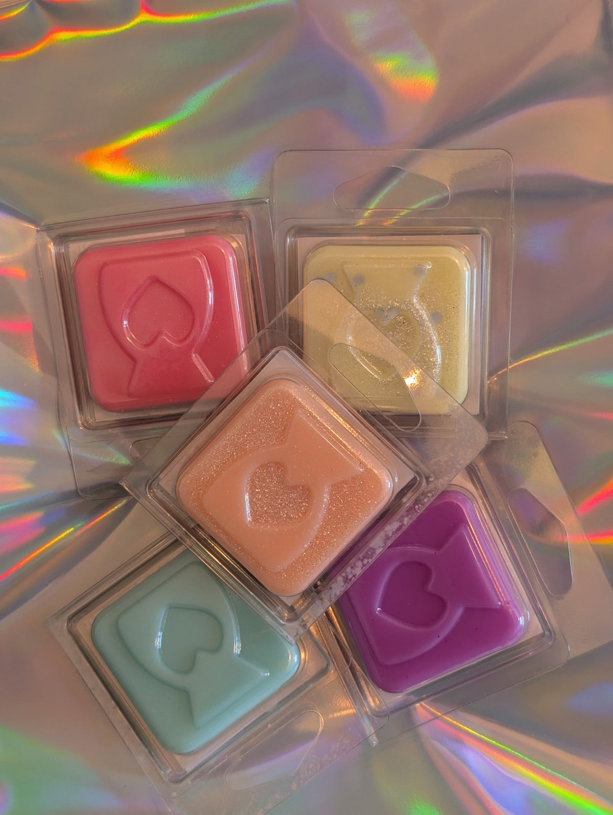 Assorted wax melt fragrance samples in heart and burner shapes
